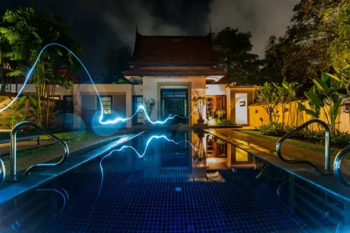 Smart home glowing with ambient blue automation lighting at night